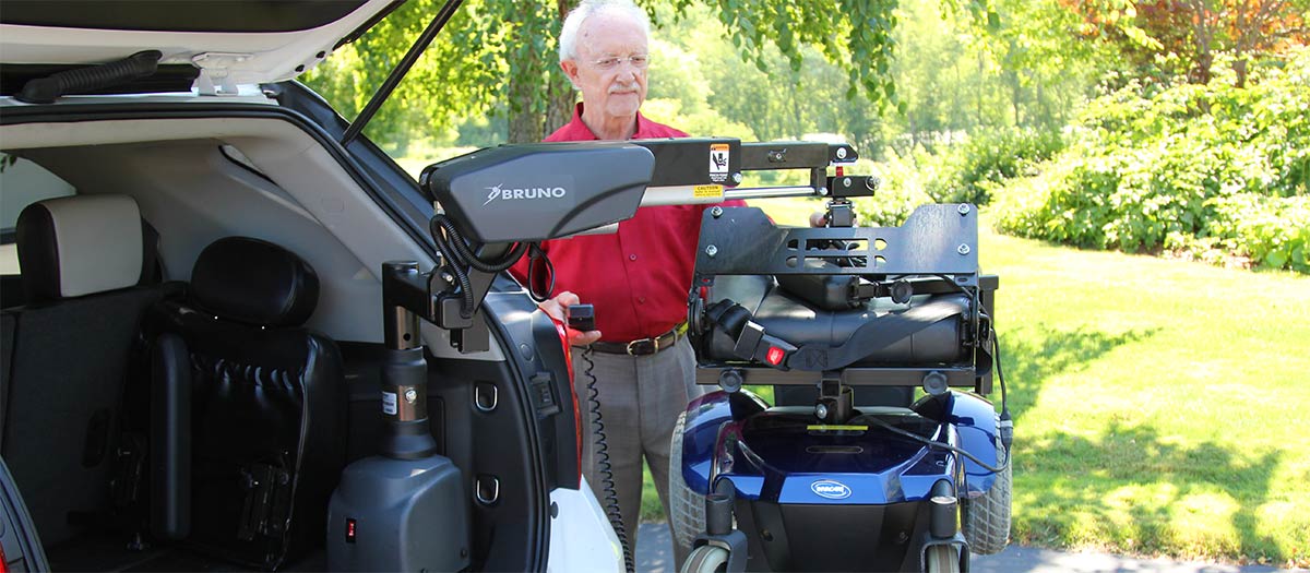 Bruno Curb-Sider hoisting up a powerchair onto a truck