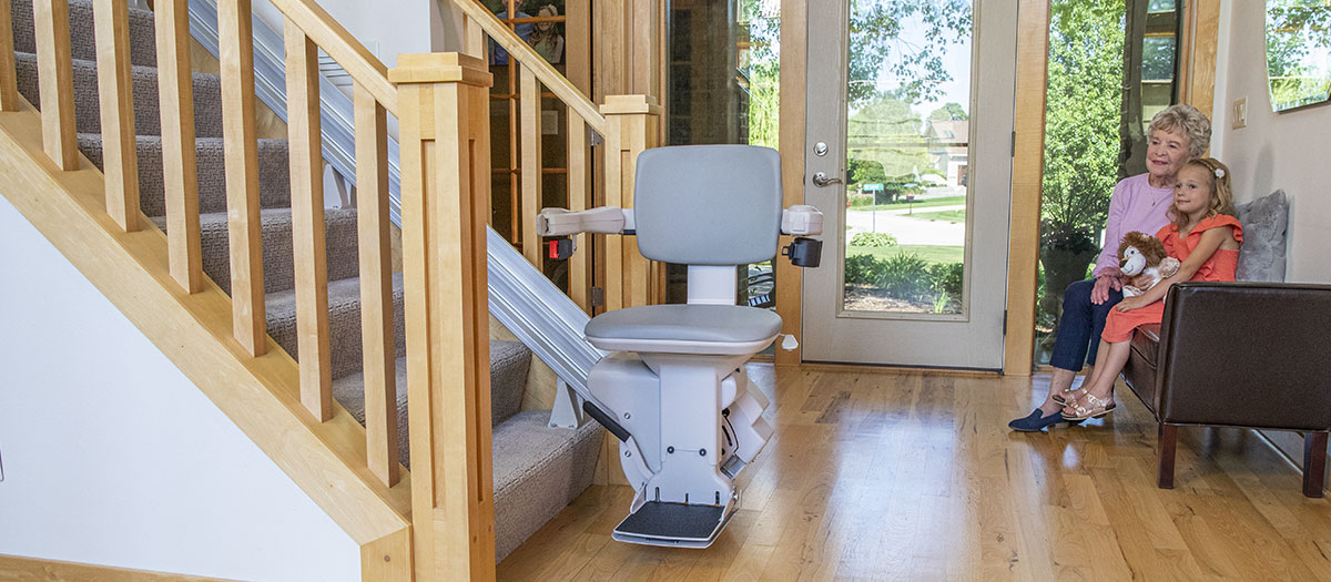 Bruno Elite straight stair lift with family in background