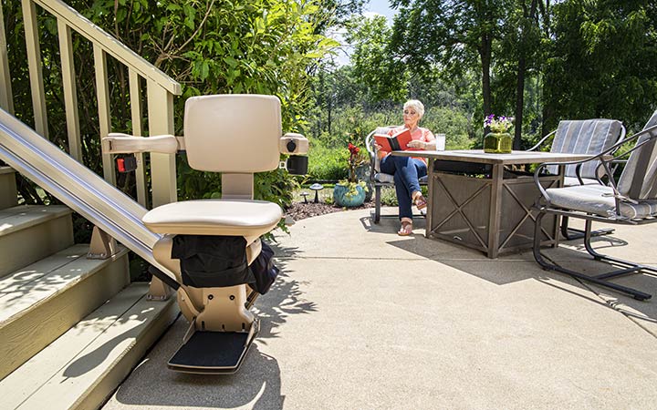 Bruno Elite straight outdoor stair lift parked at a top of staircase outside