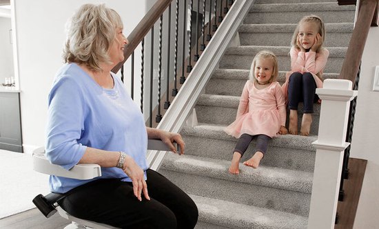 Indoor Stair Lift with female rider in a blue shirt